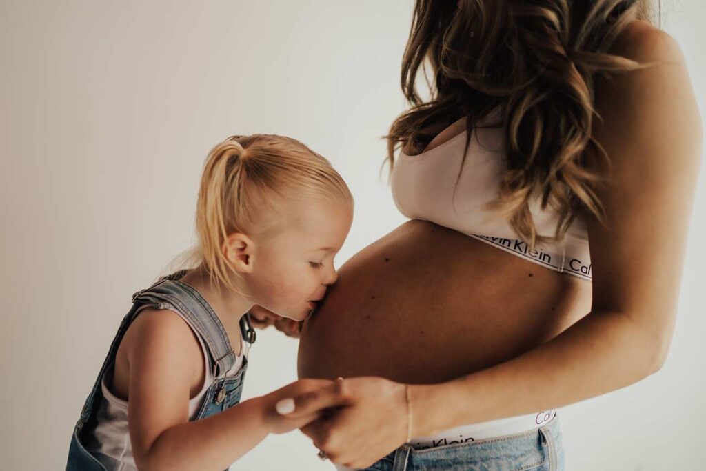 indoor mommy and daughter maternity photo