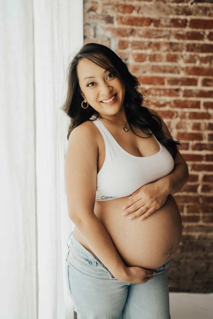 Maternity Photos with Calvin Klein sports Bra and Jeans In-Studio