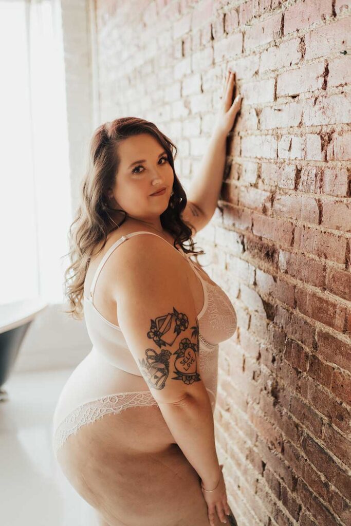 Bride in white lingerie poses for boudoir photos