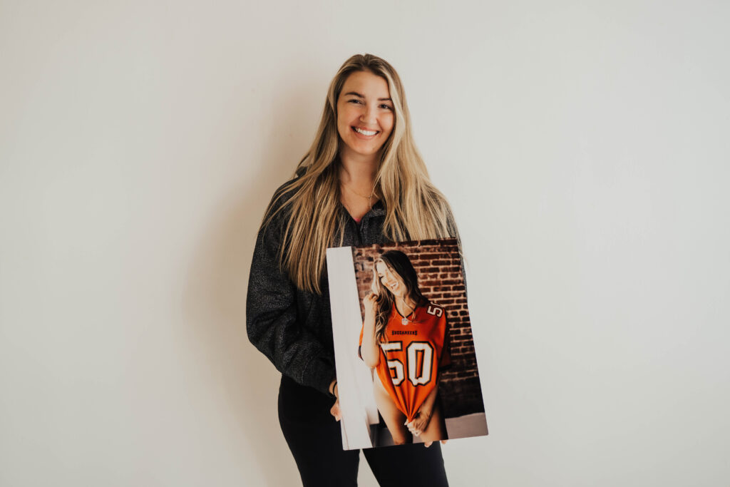 Jacksonville Bride holding wall art of boudoir photo