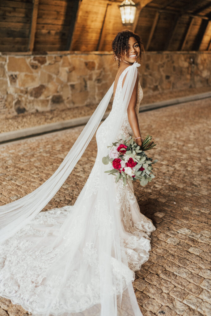 Bride posing with wedding bouquet in her dress