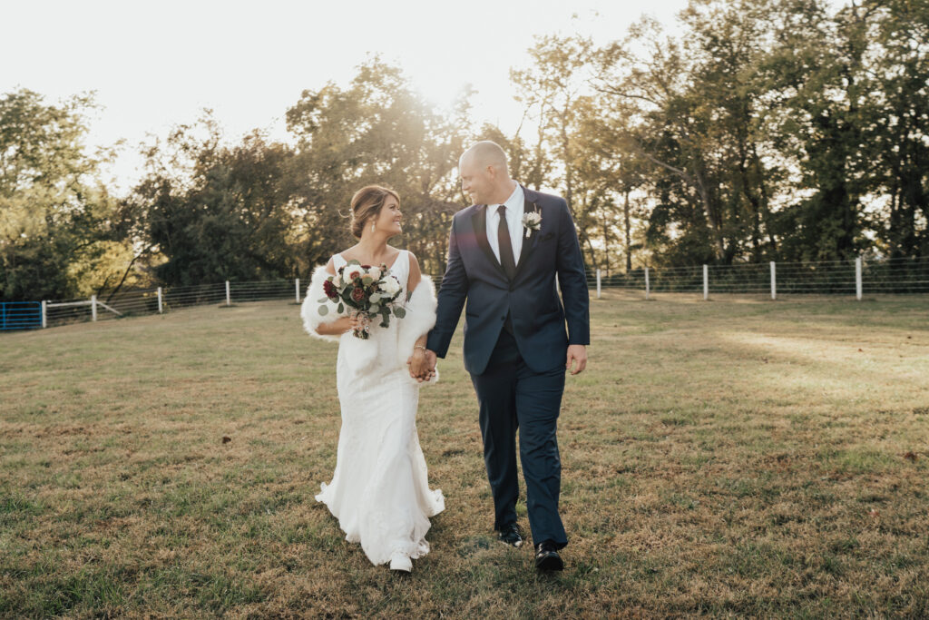 couple on wedding day holding hands and walking