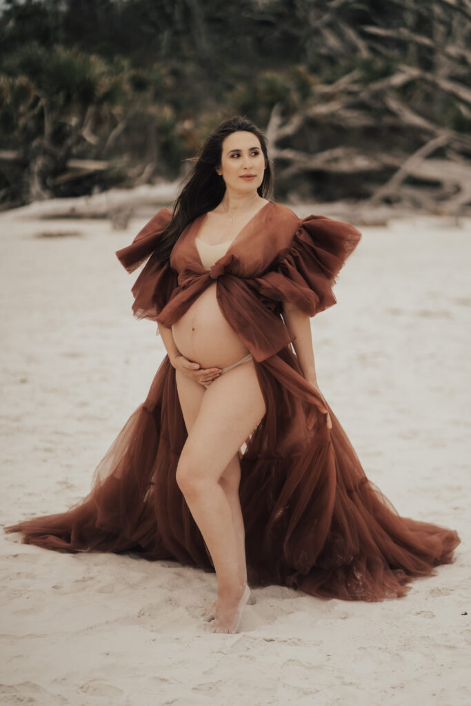 pregnant woman posing holding belly