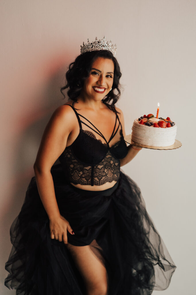 Woman holding cake celebrating life transition of her birthday