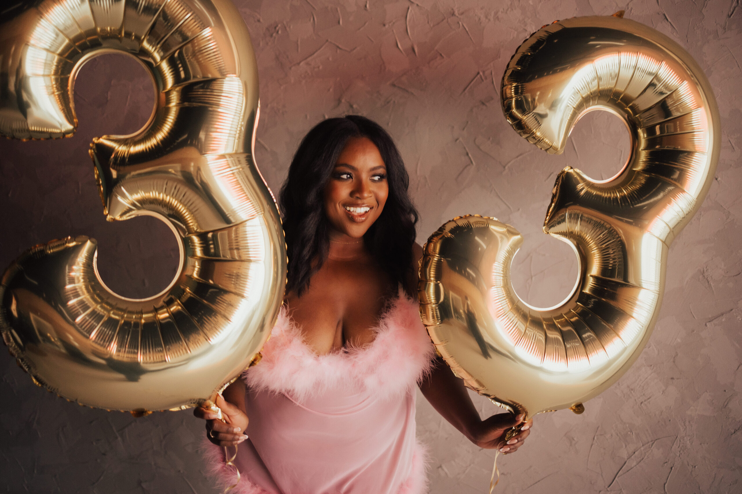 Woman holding balloons to celebrate her birthday