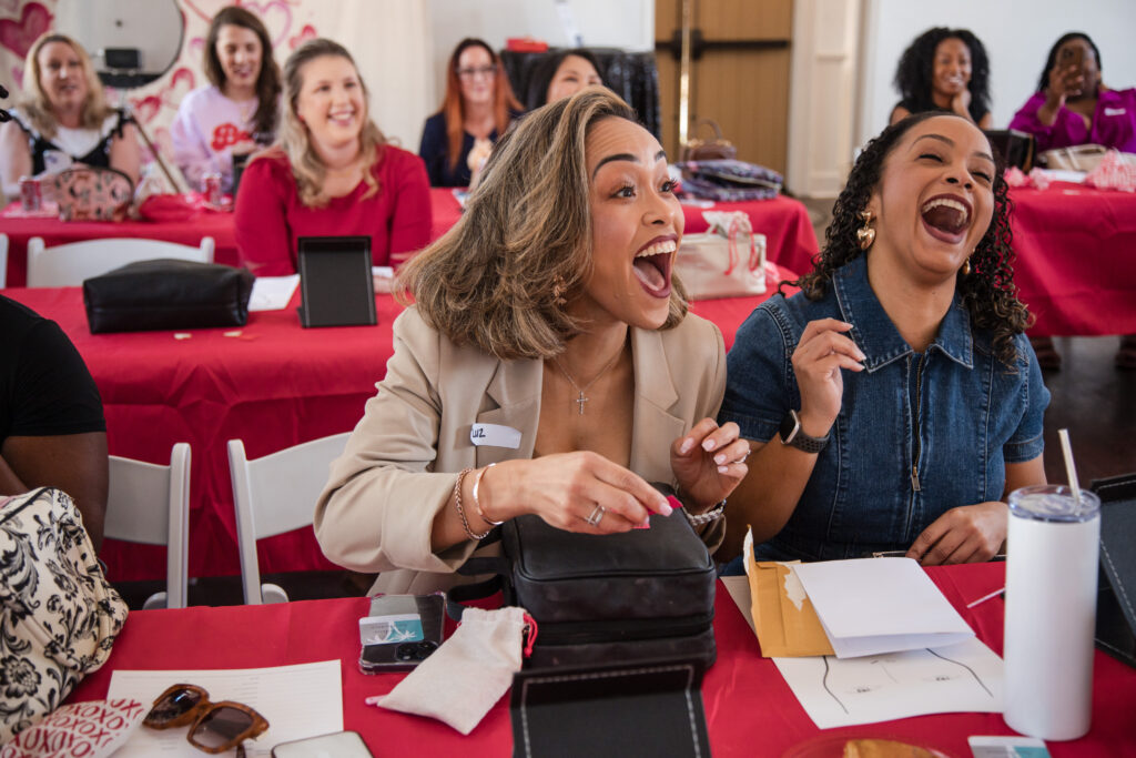 women laughing at table