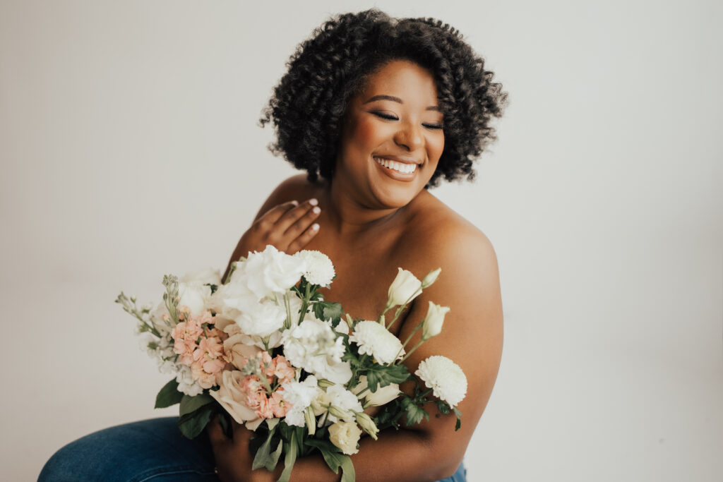 Woman holding flowers covering her chest