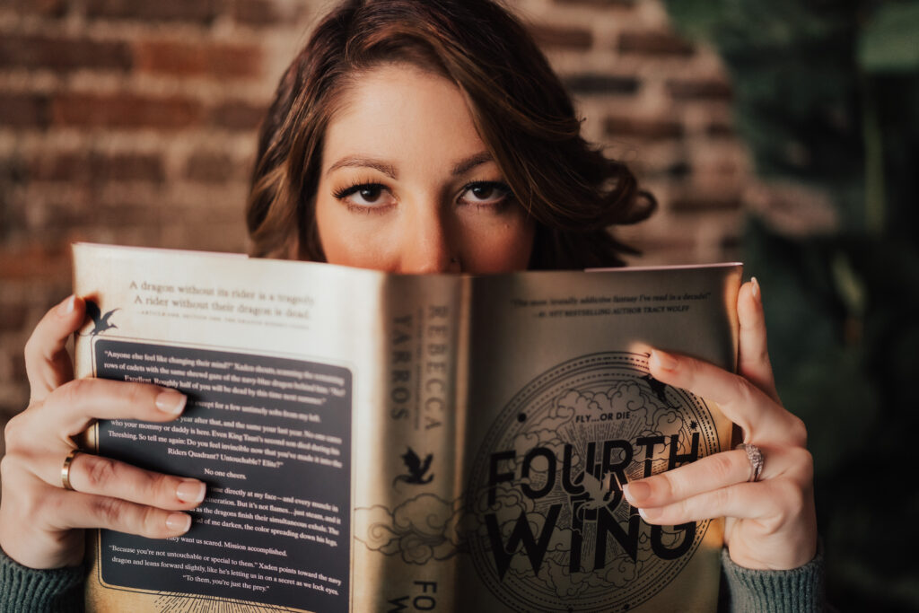 Woman eyes looking over a book in a unique boudoir photoshoot