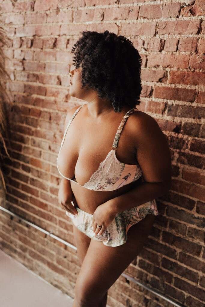 woman posing next to wall