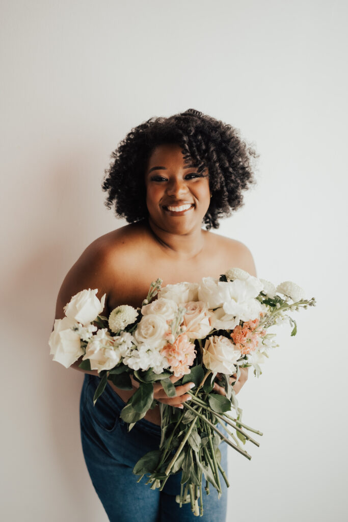 woman holding flowers over chest in boudoir photoshoot in jacksonville