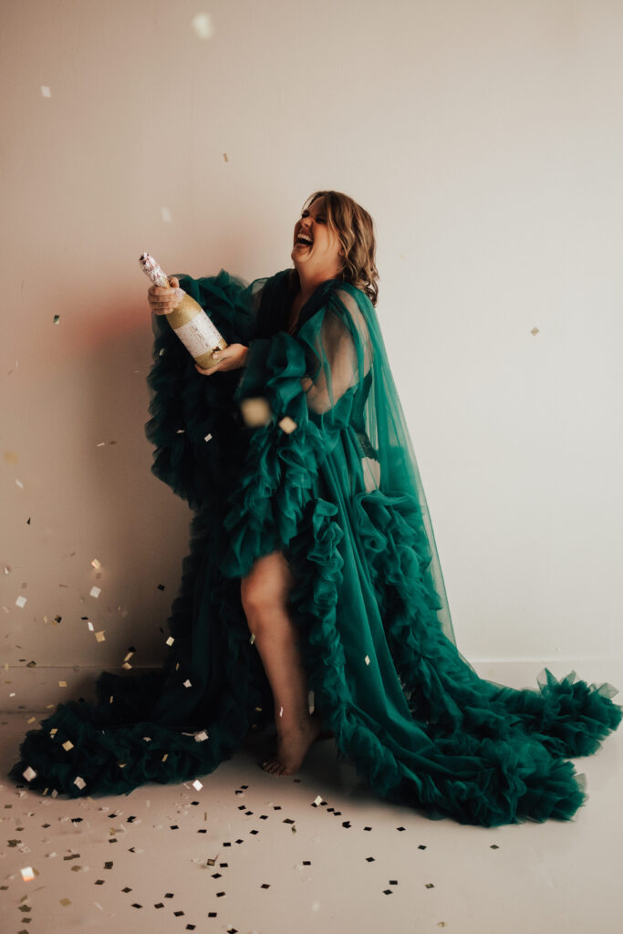 woman celebrating in robe for boudoir photoshoot